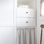 image of white shaker style pantry cabinets with white linen cabinet skirt