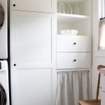 image of white shaker style pantry cabinets with white linen cabinet skirt