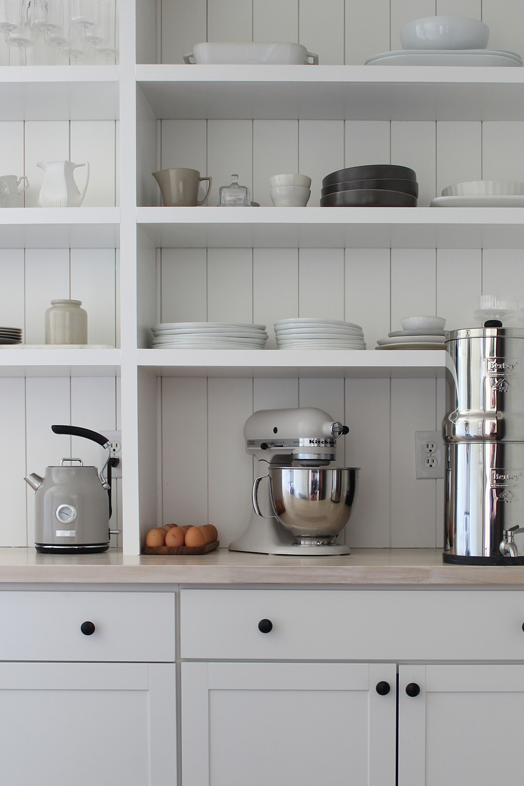simple white pantry with shiplap wall