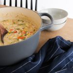 dutch oven filled with Chicken Pot Pie soup on table