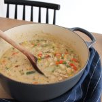 dutch oven filled with Chicken Pot Pie soup on table