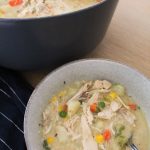 Bowl and dutch oven filled with Chicken Pot Pie soup