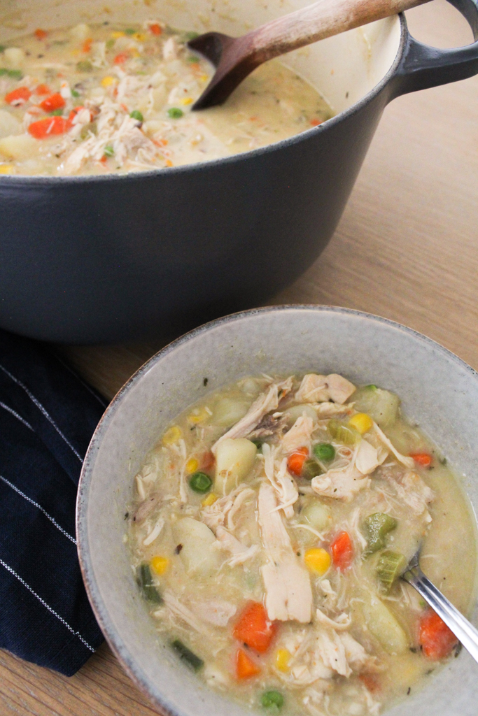 Bowl and dutch oven filled with Chicken Pot Pie soup