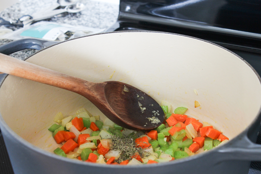 Adding seasoning to Chicken Pot Pie soup