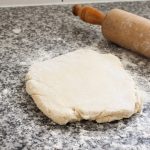 Rolling out flaky homemade biscuits dough