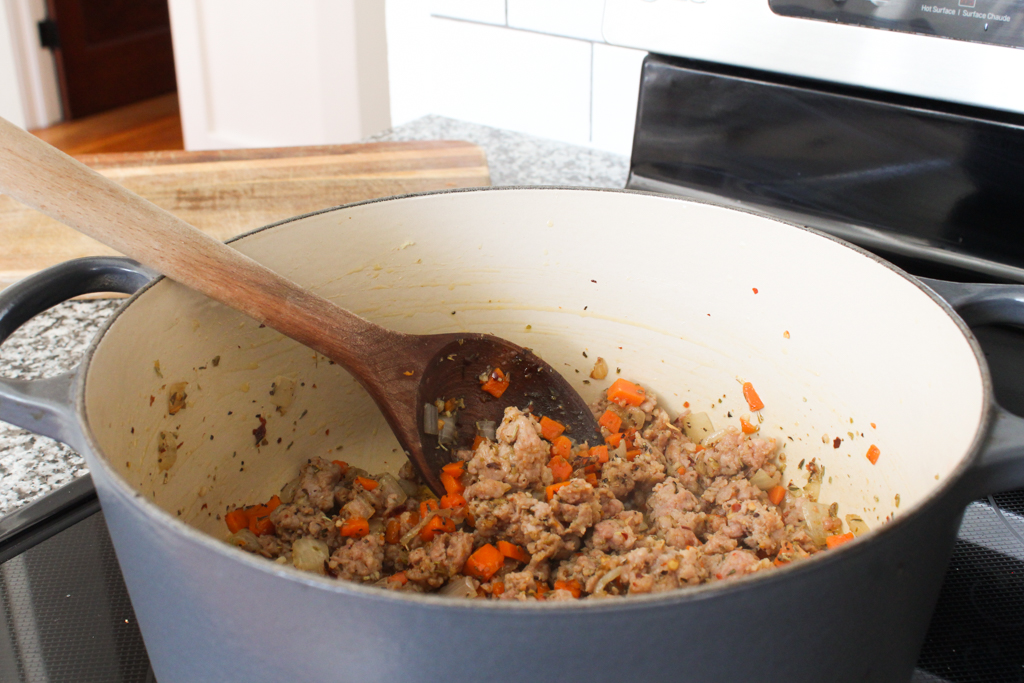 Adding seasoning to One Pot Pasta with Sausage and Kale