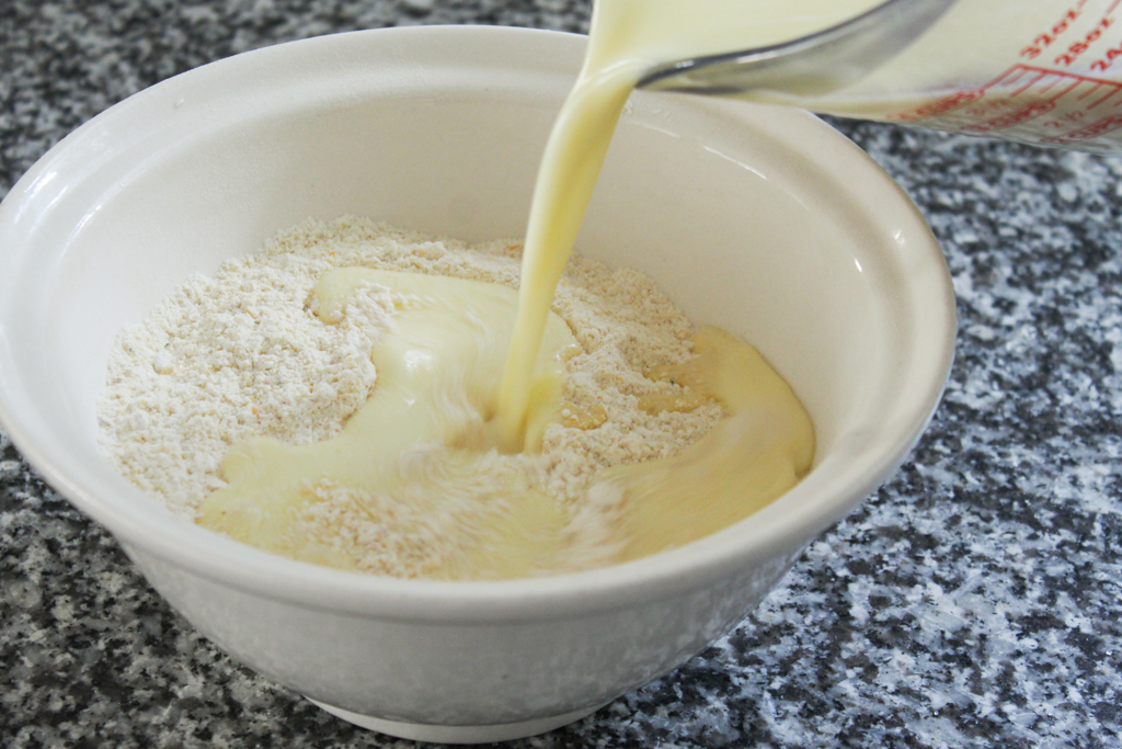 mixing wet ingredients and dry ingredients for homemade cornbread without buttermilk