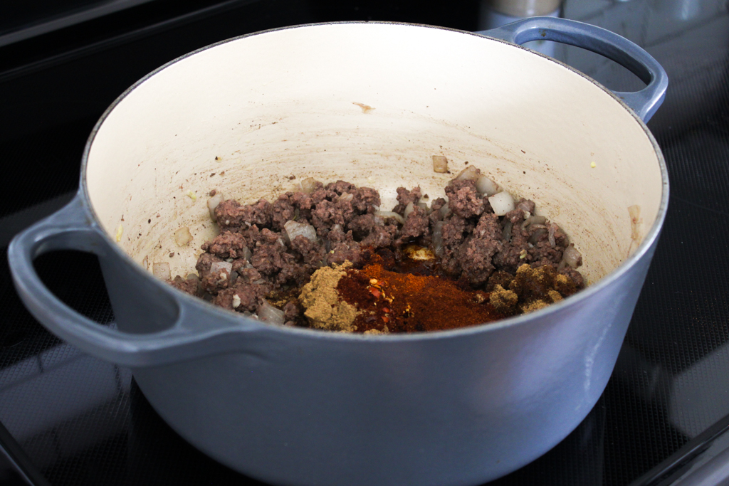 adding the spices to the chili. easy 30 minute chili with cornbread