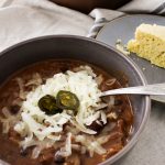 Easy 30 minute meal recipe for chipotle chili and homemade cornbread from-scratch in the background