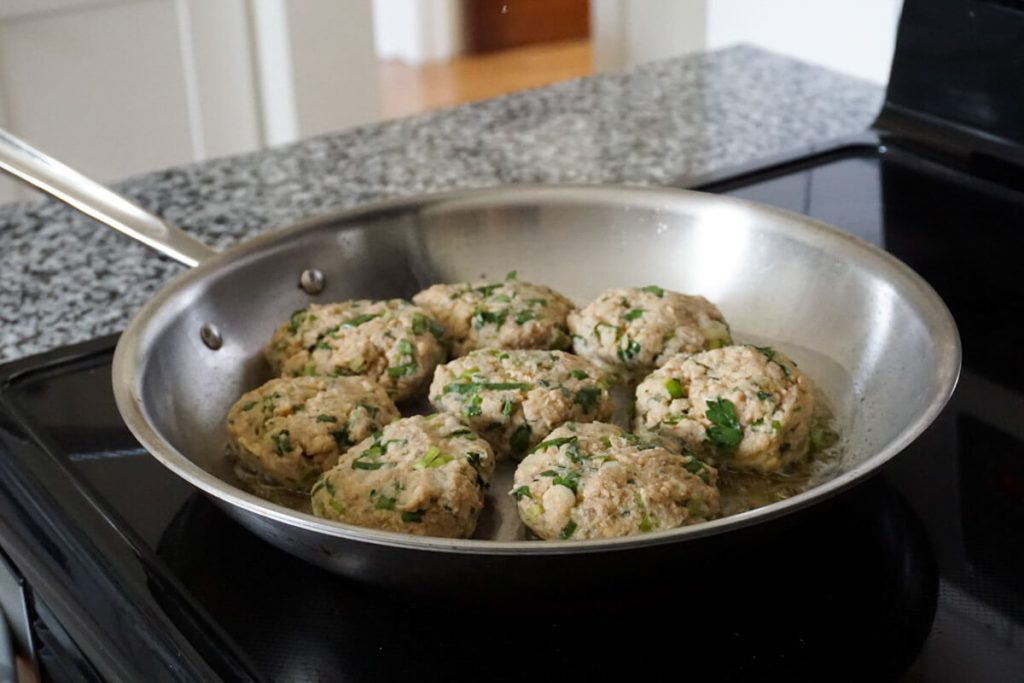 Cooking salmon patties in a large skillet