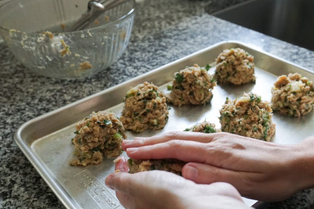 Pressing mixture into patties to make salmon cakes step by step