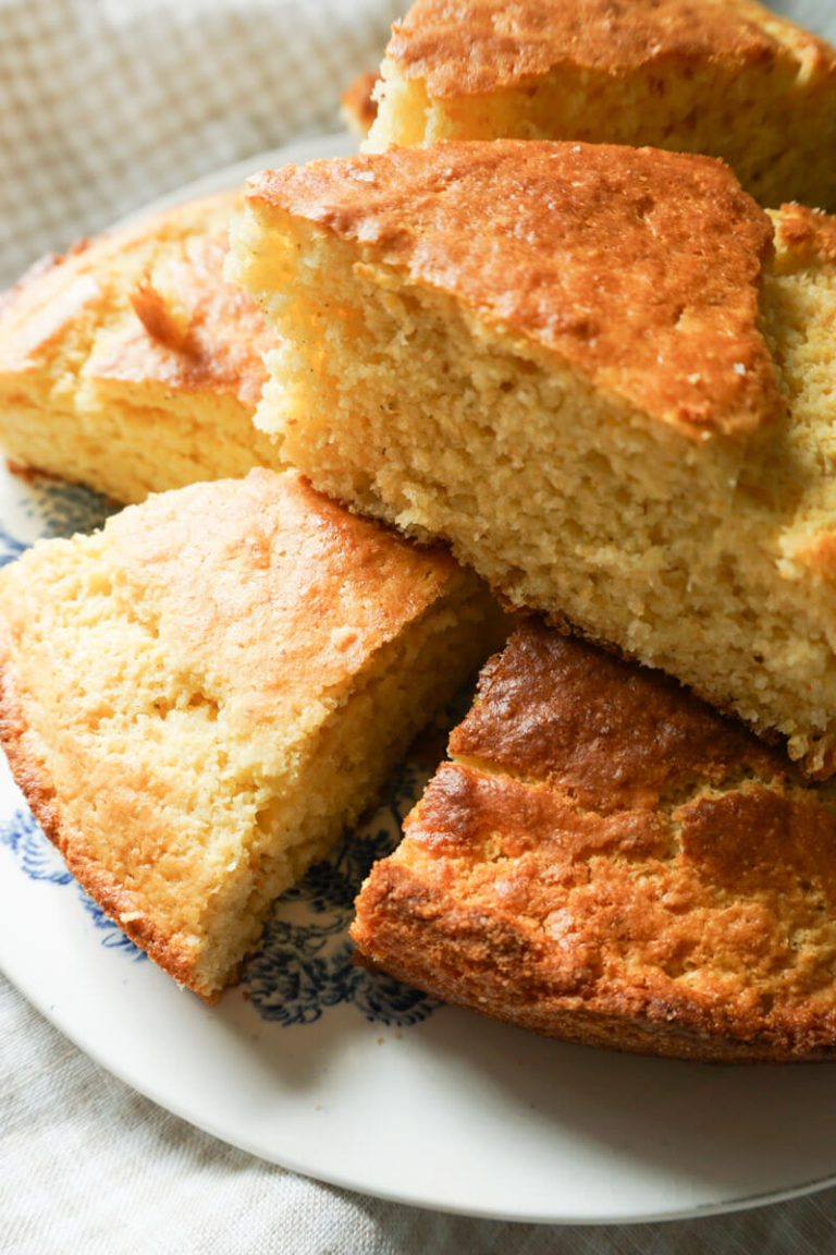 Slices of homemade cornbread stacked on a plate