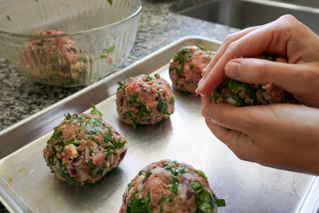 Shaping homemade Greek turkey burger mix into patties