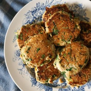 Plate of fresh salmon cakes with lemon and parsley