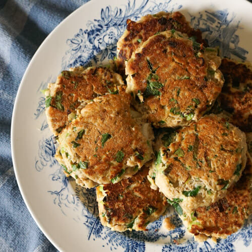Plate of fresh salmon cakes with lemon and parsley