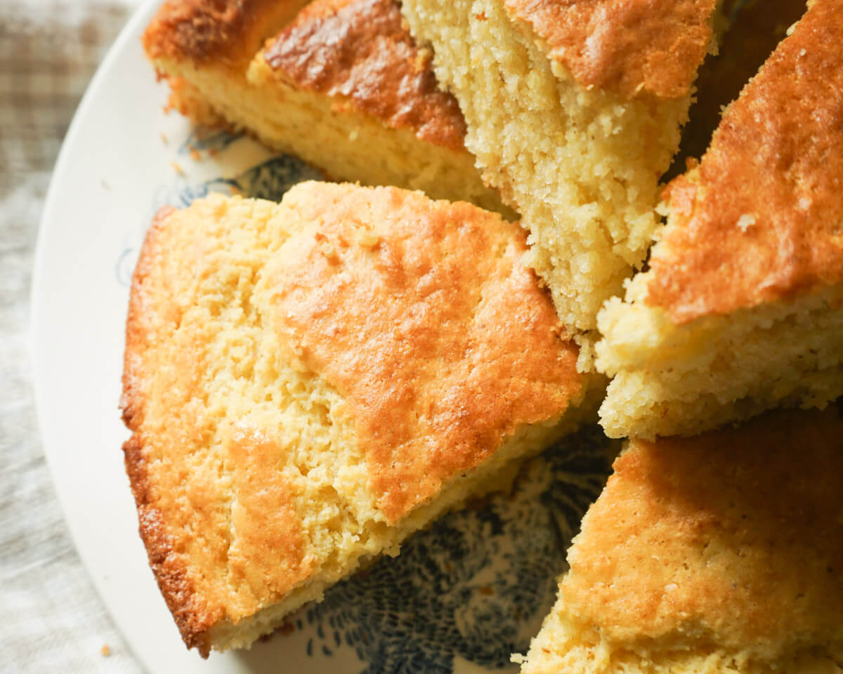 Slices of from-scratch cornbread stacked on a plate