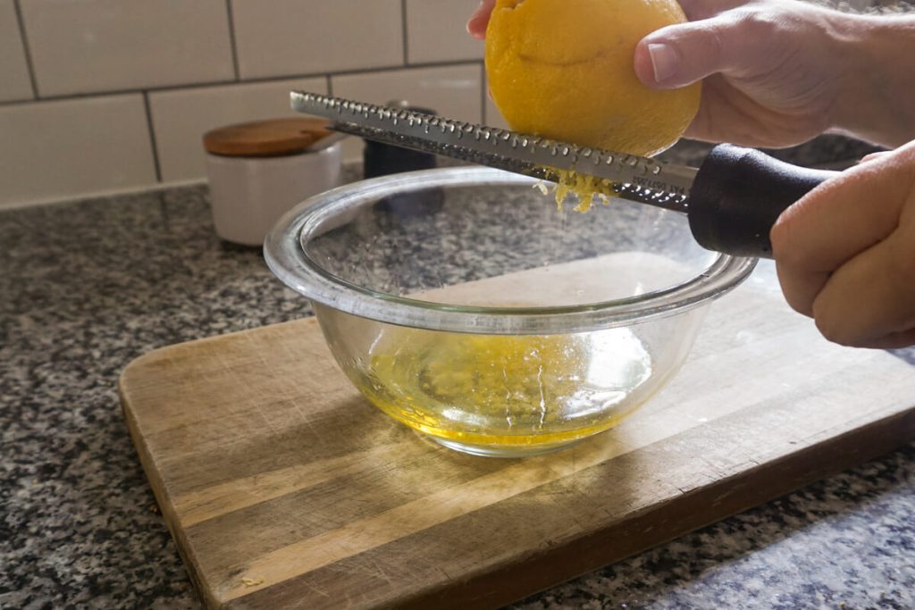 Zesting lemon for homemade chimichurri sauce recipe
