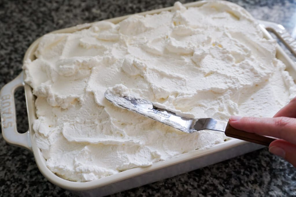 Adding whipped cream to banana pudding for a crowd