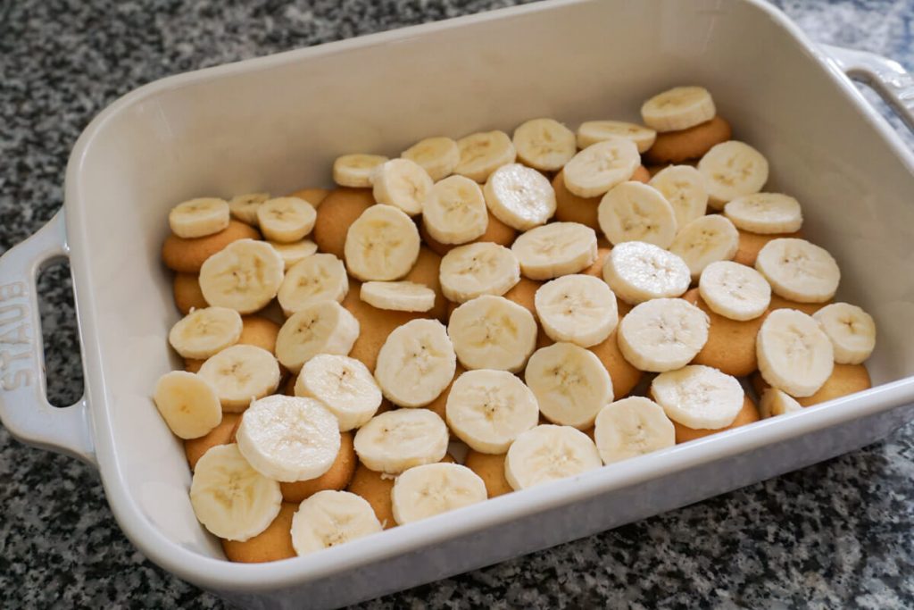 Layers of vanilla wafers and sliced bananas for homemade banana pudding made without instant pudding mix