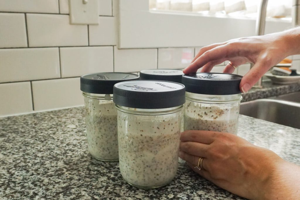 meal prepping chia pudding for the week in mason jars