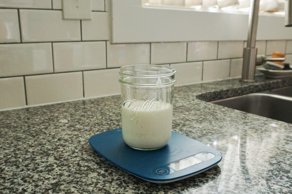 measuring liquid ingredients for chia pudding on kitchen scale