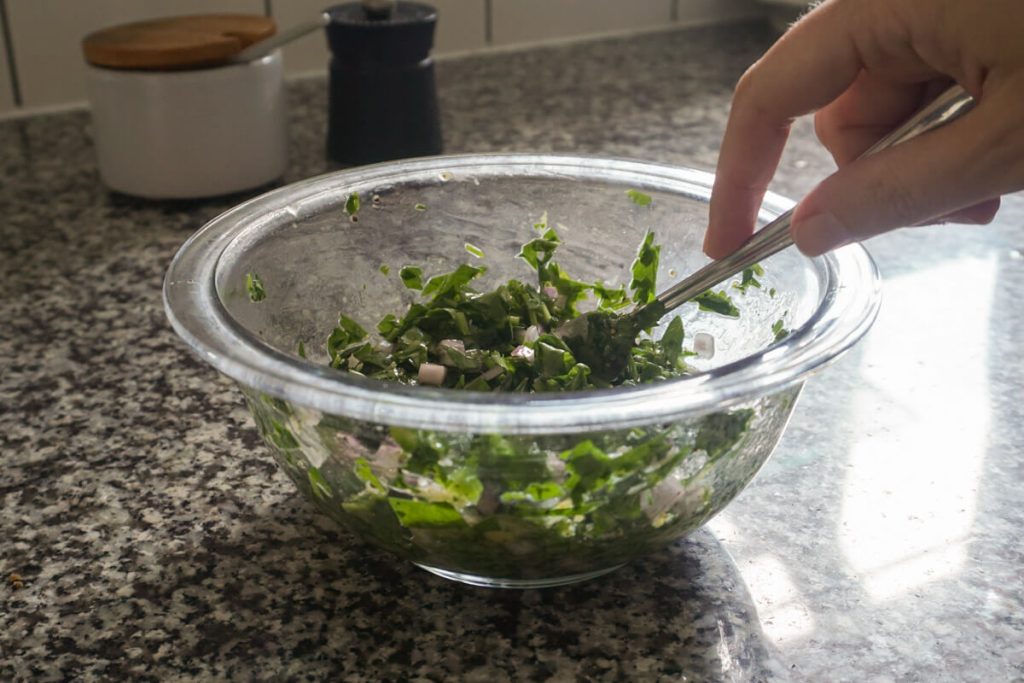 Mixing ingredients for fresh chimichurri sauce