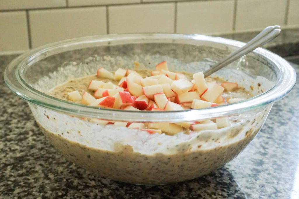 adding apples to apple pie baked oatmeal batter