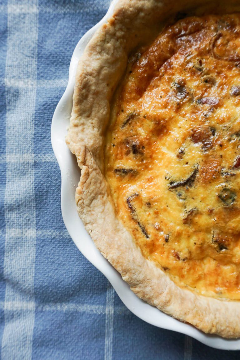 Easy cheese and bacon quiche with homemade crust in pie dish