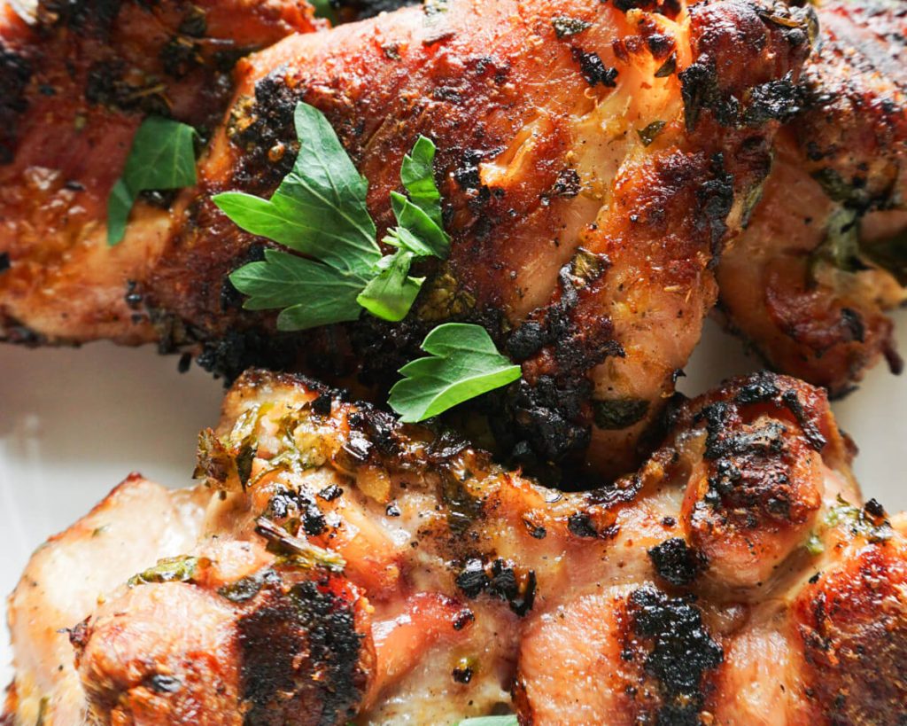 close up of grilled greek chicken thighs