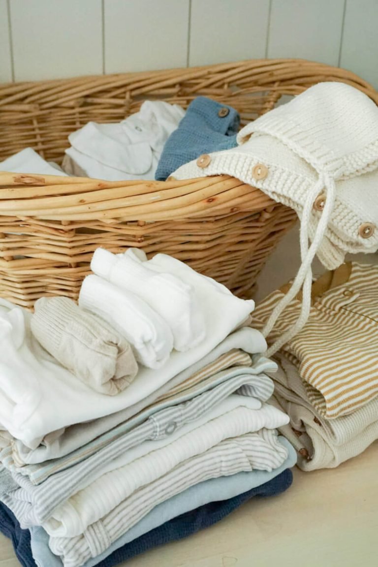 Basket of baby clothes and other intentional newborn essentials