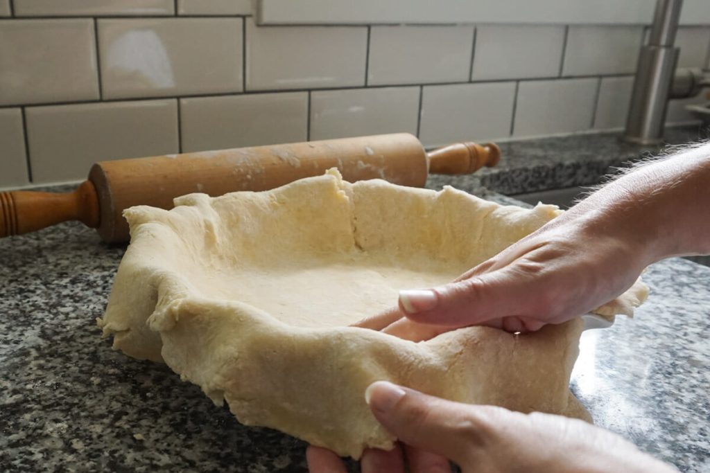 Pressing homemade crust into pie dish