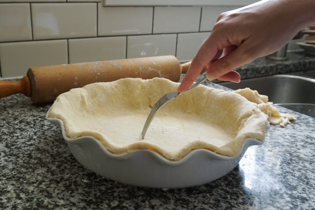 Pricking homemade crust for blind baking