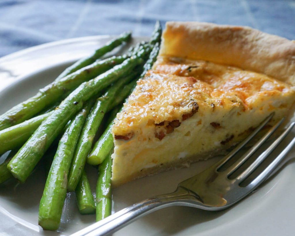 Quiche served with sautéed asparagus